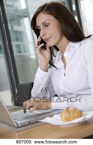 A woman working at her desk View Large Photo Image Stock Photography - A woman working at her desk. Fotosearch