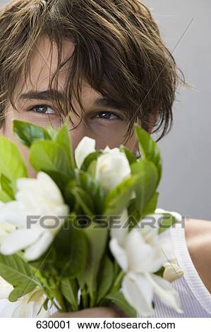 Stock Image - A Young Man holding a bouquet of flowers. Fotosearch