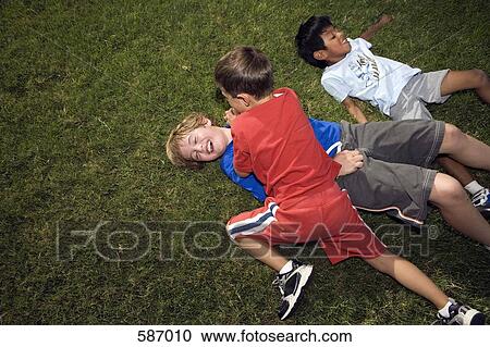 Boys Roughing Housing outside on Lawn View Large Photo Image Stock Image - Boys Roughing Housing outside on Lawn. Fotosearch