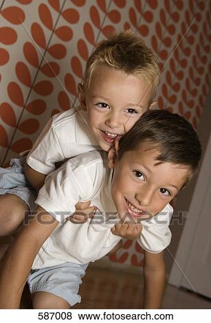 Stock Photo - Close-Up of Boys Rough Housing. Fotosearch