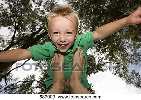 Smiling Young Boy balancing on feet View Large Photo Image Stock Image - Smiling Young Boy balancing on feet. Fotosearch