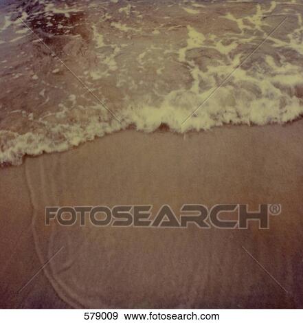Surf washing up onto a beach View Large Photo Image Stock Photo - Surf washing up onto a beach. Fotosearch