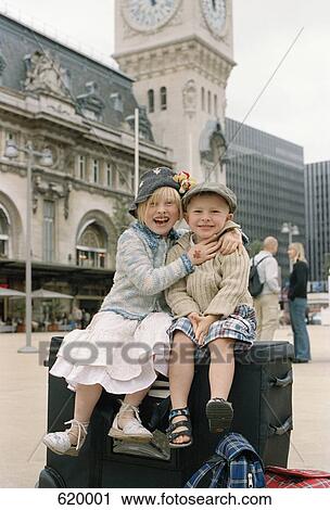 Two children sitting on luggage outside the Gare de Lyon, Paris View Large Photo Image Stock Image - Two children sitting on luggage outside the Gare de Lyon, Paris. Fotosearch