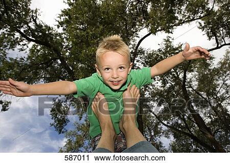 Young boy balanced on feet with arms out View Large Photo Image Stock Image - Young boy balanced on feet with arms out. Fotosearch