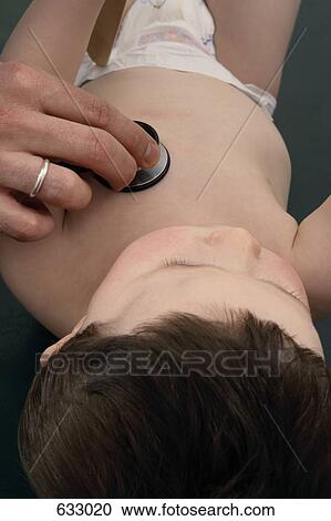 Stock Image - A baby boy being examined with a stethoscope. Fotosearch