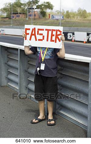 A boy holding a ‘Faster’ sign View Large Photo Image Stock Image - A boy holding a ‘Faster’ sign. Fotosearch