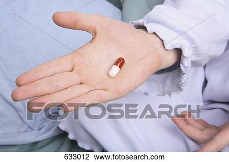 A child’s hand holding a capsule View Large Photo Image Stock Image - A child’s hand holding a capsule. Fotosearch