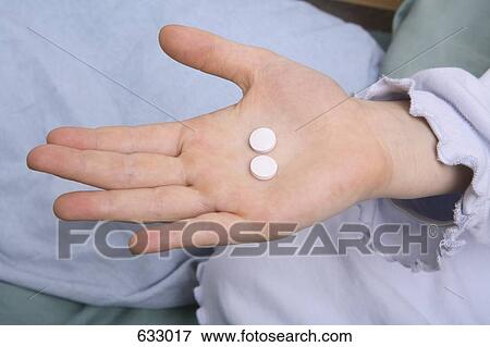 A child’s hand holding two tablets View Large Photo Image Stock Photo - A child’s hand holding two tablets. Fotosearch