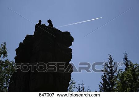 A couple sitting on top of a rock, Fichtelgebirge, Germany View Large Photo Image Stock Photo - A couple sitting on top of a rock, Fichtelgebirge, Germany. Fotosearch