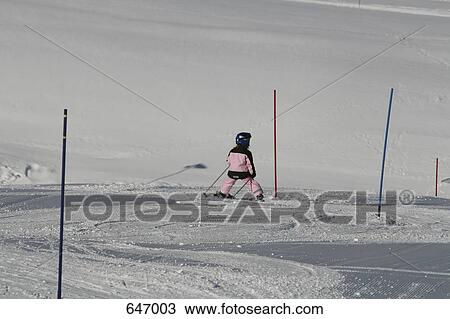 Stock Image - A girl practicing skiing, Graubunden, Switzerland. Fotosearch