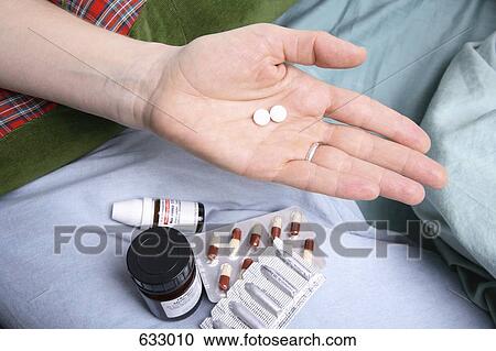 A human hand holding two pills View Large Photo Image Stock Image - A human hand holding two pills. Fotosearch