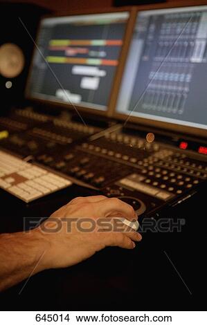 Picture - A human hand using sound recording equipment. Fotosearch