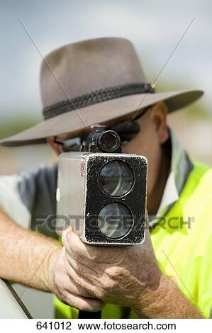 A man holding a speed camera View Large Photo Image Stock Image - A man holding a speed camera. Fotosearch