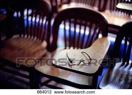 A pair of eyeglasses on a wood school desk View Large Photo Image Stock Image - A pair of eyeglasses on a wood school desk. Fotosearch