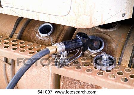 A petrol pump refueling a truck View Large Photo Image Stock Photo - A petrol pump refueling a truck. Fotosearch