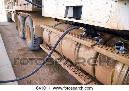 A petrol pump refueling a truck View Large Photo Image Stock Photo - A petrol pump refueling a truck. Fotosearch