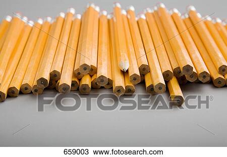 Stock Image - A pile of unsharpened pencils with one sharpened pencil in the middle. Fotosearch