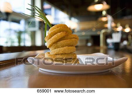 A plated stack of fried onion rings View Large Photo Image Stock Image - A plated stack of fried onion rings. Fotosearch