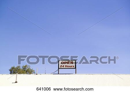 ‘Open 24 Hours’ sign on top of a roof View Large Photo Image Stock Photograph - ‘Open 24 Hours’ sign on top of a roof. Fotosearch