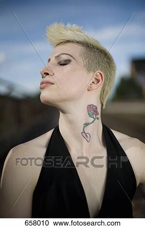 Profile of a young woman with a mohawk holding her head back View Large Photo Image Stock Image - Profile of a young woman with a mohawk holding her head back. Fotosearch