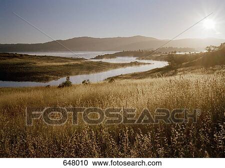 Scenic shot of fields, river and a mountain View Large Photo Image Stock Image - Scenic shot of fields, river and a mountain. Fotosearch