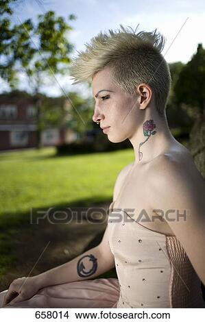 Side view portrait of a young punk woman in an evening gown outside View Large Photo Image Picture - Side view portrait of a young punk woman in an evening gown outside. Fotosearch