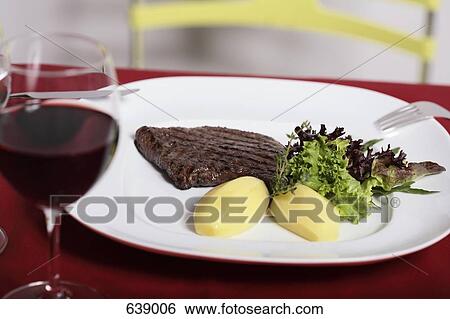 Still life, plate of steak and boiled potatoes, filled red wine glass View Large Photo Image Stock Photograph - Still life, plate of steak and boiled potatoes, filled red wine glass. Fotosearch