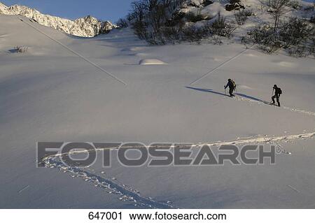 Two hikers walking through snow, Andermatt, Uri, Switzerland View Large Photo Image Stock Image - Two hikers walking through snow, Andermatt, Uri, Switzerland. Fotosearch