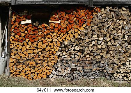 Stock Image - Wood Stacked under a shelter. Fotosearch