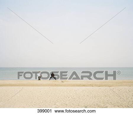 A beach at the Baltic Sea, Germany with two unrecognizable people in the distance View Large Photo Image Stock Image - A beach at the Baltic Sea, Germany with two unrecognizable people in the distance. Fotosearch