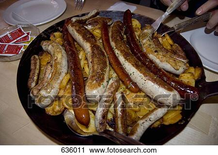 A cast iron pan full of potatoes, and various sausages View Large Photo Image Stock Image - A cast iron pan full of potatoes, and various sausages. Fotosearch