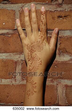A henna tattoo on a woman's hand and arm View Large Photo Image Stock Image - A henna tattoo on a woman's hand and arm. Fotosearch