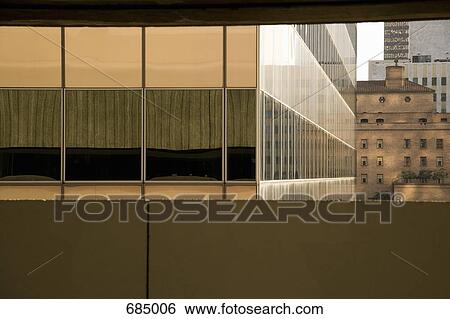 A modern office building in front of an old apartment building View Large Photo Image Stock Photograph - A modern office building in front of an old apartment building. Fotosearch