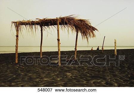 A Palapa shelter on a beach View Large Photo Image Stock Photo - A Palapa shelter on a beach. Fotosearch