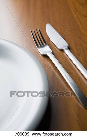A plate and silverware on a table View Large Photo Image Stock Photo - A plate and silverware on a table. Fotosearch