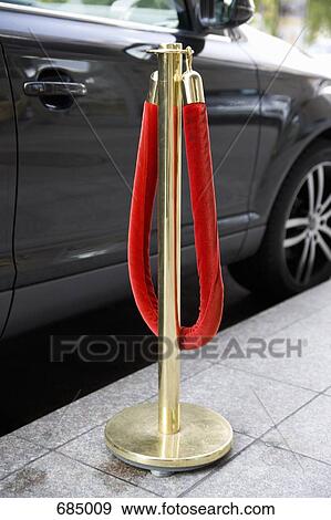 A red velvet rope next to a parked car View Large Photo Image Stock Photo - A red velvet rope next to a parked car. Fotosearch