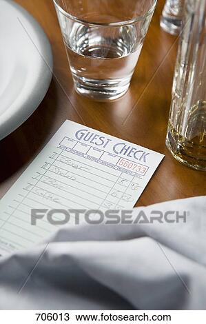 A restaurant check on a table View Large Photo Image Stock Image - A restaurant check on a table. Fotosearch