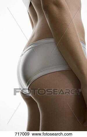 Stock Photo - A woman wearing silver underwear. Fotosearch