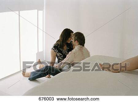 Stock Image - A young couple sharing an intimate moment. Fotosearch