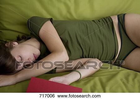 A young woman asleep on a couch View Large Photo Image Stock Photograph - A young woman asleep on a couch. Fotosearch