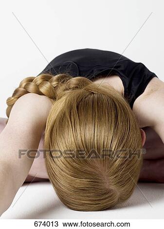 A young woman bending over and resting her head on the floor View Large Photo Image Stock Image - A young woman bending over and resting her head on the floor. Fotosearch