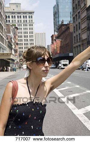 A young woman hailing a taxi, Brooklyn, New York View Large Photo Image Stock Photo - A young woman hailing a taxi, Brooklyn, New York. Fotosearch
