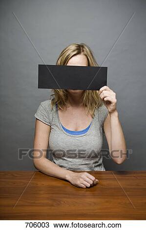 A young woman holding a censorship strip in front of her face View Large Photo Image Stock Image - A young woman holding a censorship strip in front of her face. Fotosearch