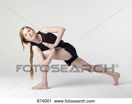 A young woman practicing the 'Prayer Twist' yoga pose View Large Photo Image Stock Image - A young woman practicing the 'Prayer Twist' yoga pose. Fotosearch
