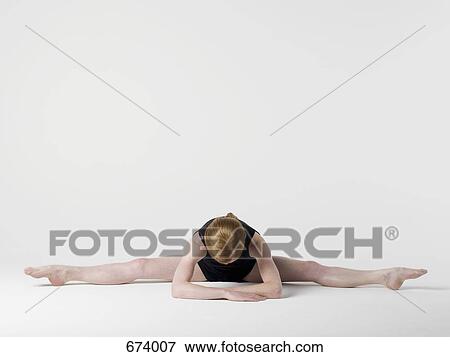 A young woman practicing the 'Spread Leg Forward Fold' yoga pose View Large Photo Image Stock Photo - A young woman practicing the 'Spread Leg Forward Fold' yoga pose. Fotosearch