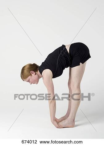 A young woman practicing the 'Upward Forward Fold' yoga pose View Large Photo Image Stock Image - A young woman practicing the 'Upward Forward Fold' yoga pose. Fotosearch