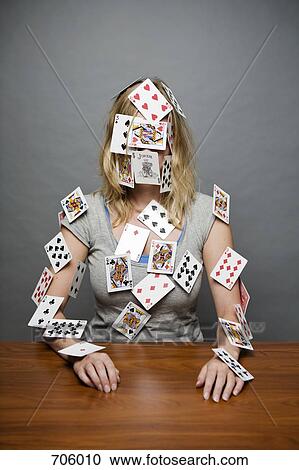 Stock Image - A young woman with cards stuck all over her. Fotosearch
