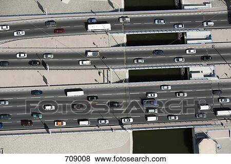 Aerial view of vehicles driving along a motorway View Large Photo Image Stock Photo - Aerial view of vehicles driving along a motorway. Fotosearch