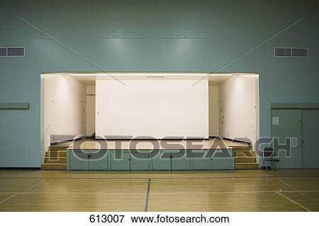 An illuminated stage in a gymnasium View Large Photo Image Stock Photo - An illuminated stage in a gymnasium. Fotosearch