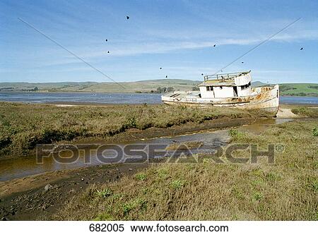 Stock Photography - An old ship beached and rotting. Fotosearch